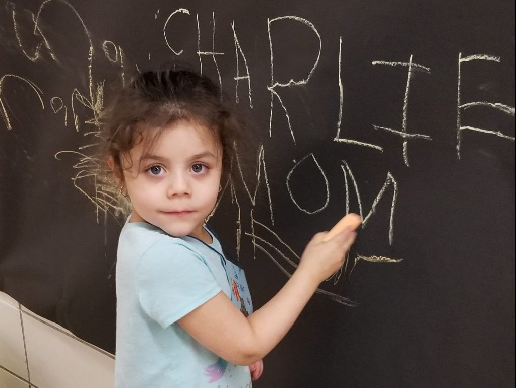 student at chalkboard