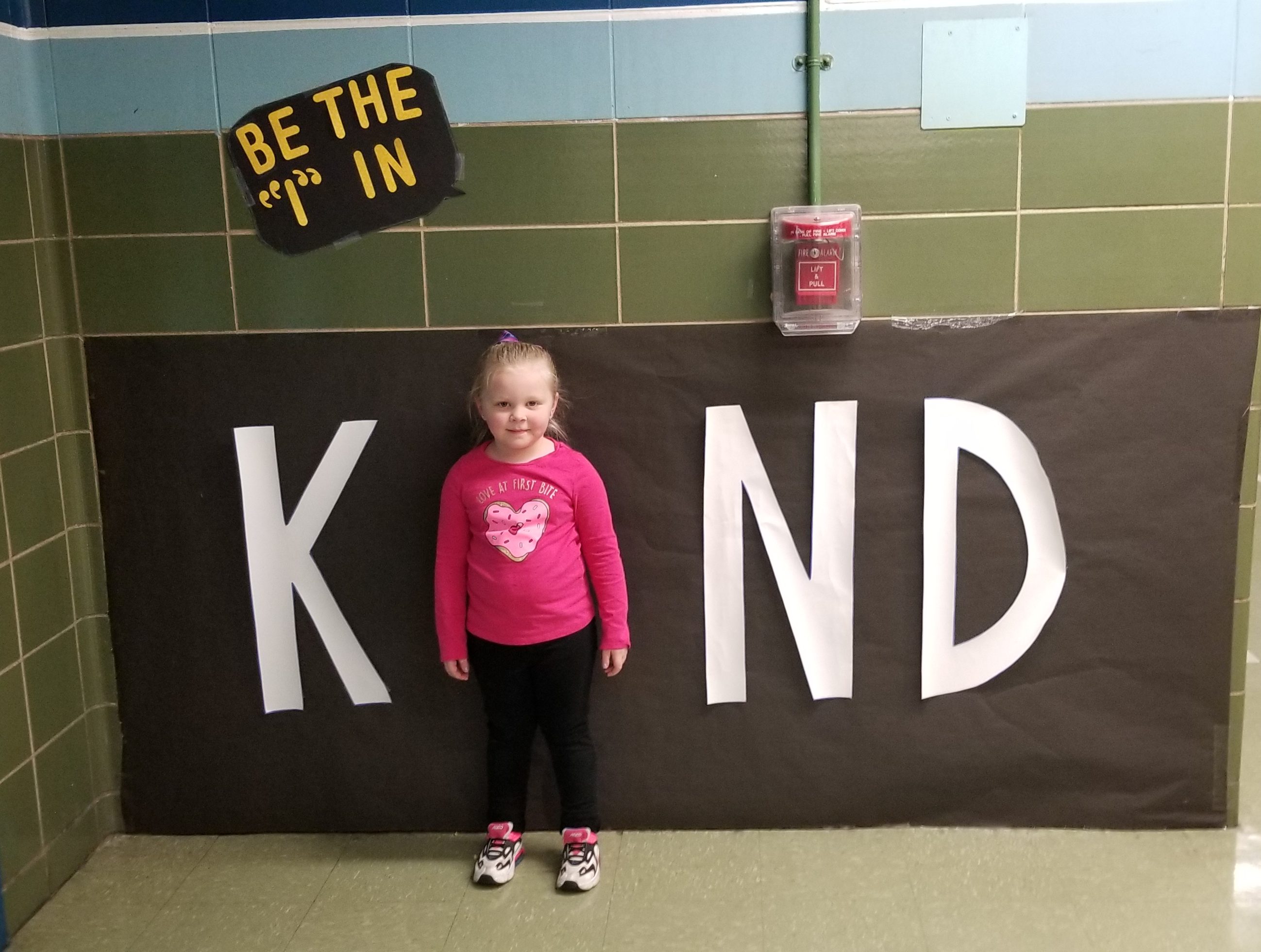 Student in a Kind sign